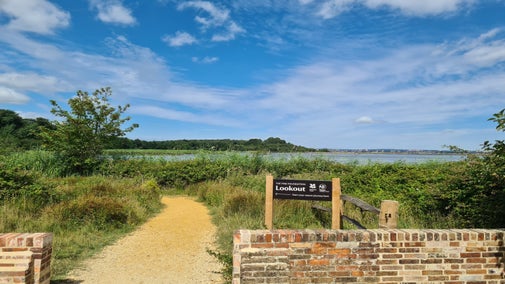 The entrance path from Reception to The Lookout with Brownsea Lagoon in the background.